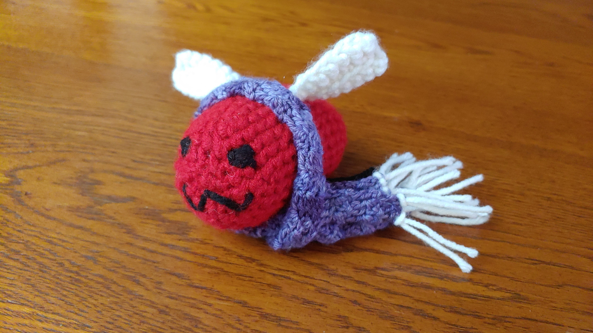 Amigurumi Eggbug wearing a little scarf.