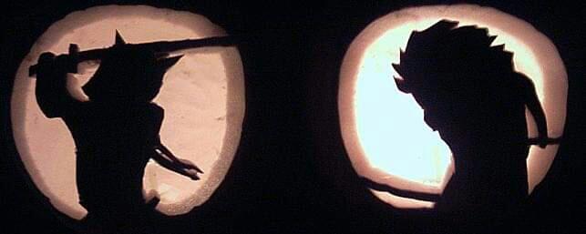 Pair of pumpkin carvings of card art from Legend of the Five Rings. Two samurai square off for battle.