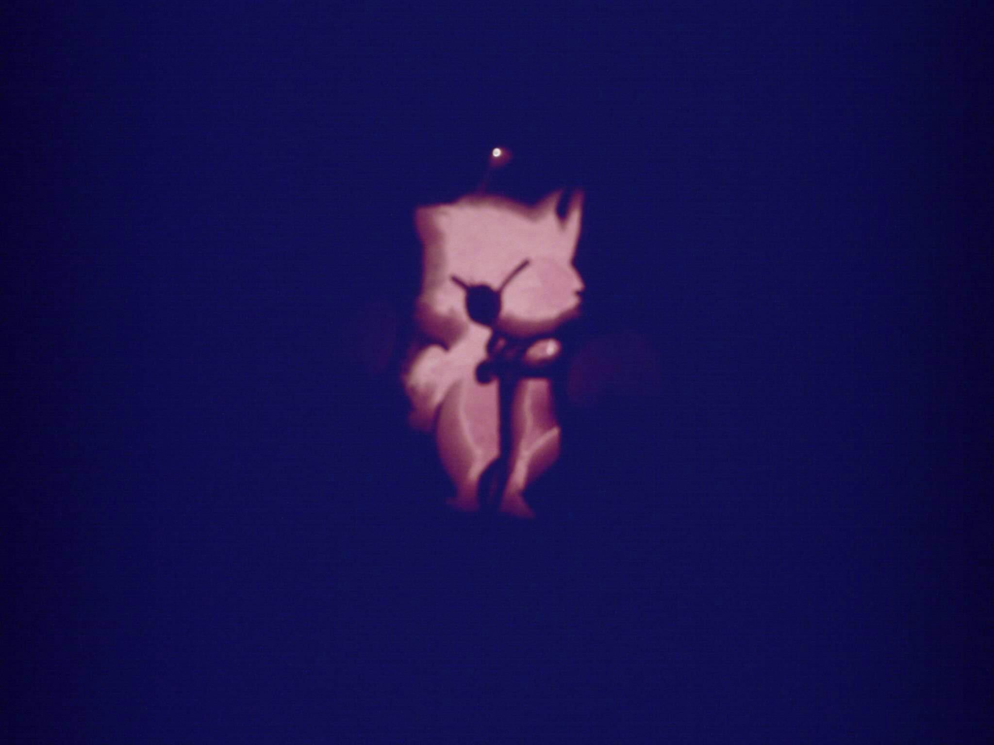 Pumpkin carving of Mog the moogle from Final Fantasy 6, a furry little creature somewhere between a mole and a bat, leaning on a dagger.