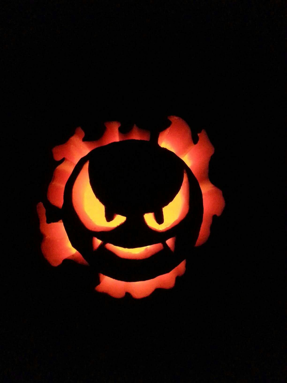 Pumpkin carving of Gastly from Pokemon, a gaseous round ghost that is largely a menacing face.
