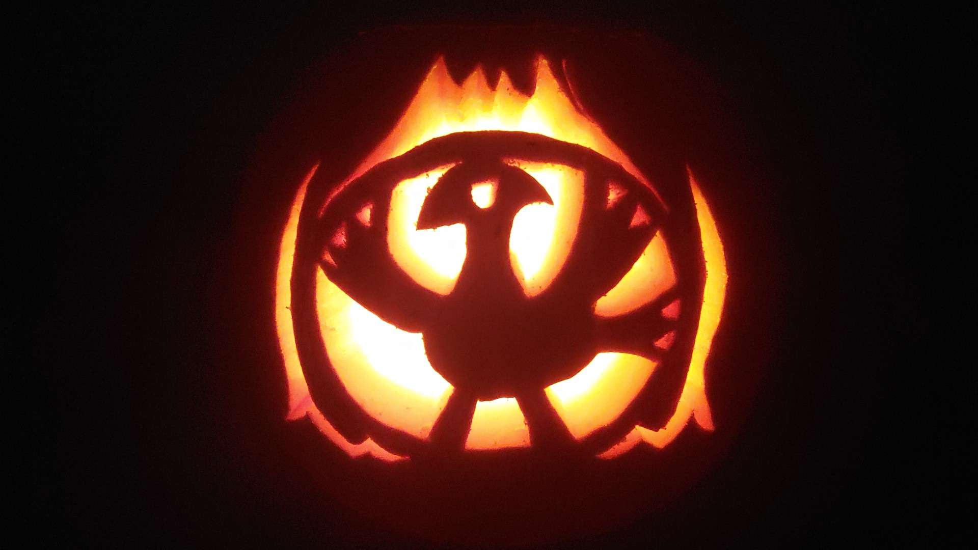 Pumpkin carving of a red chocobo from Final Fantasy Tactics summoning a choco-meteor.